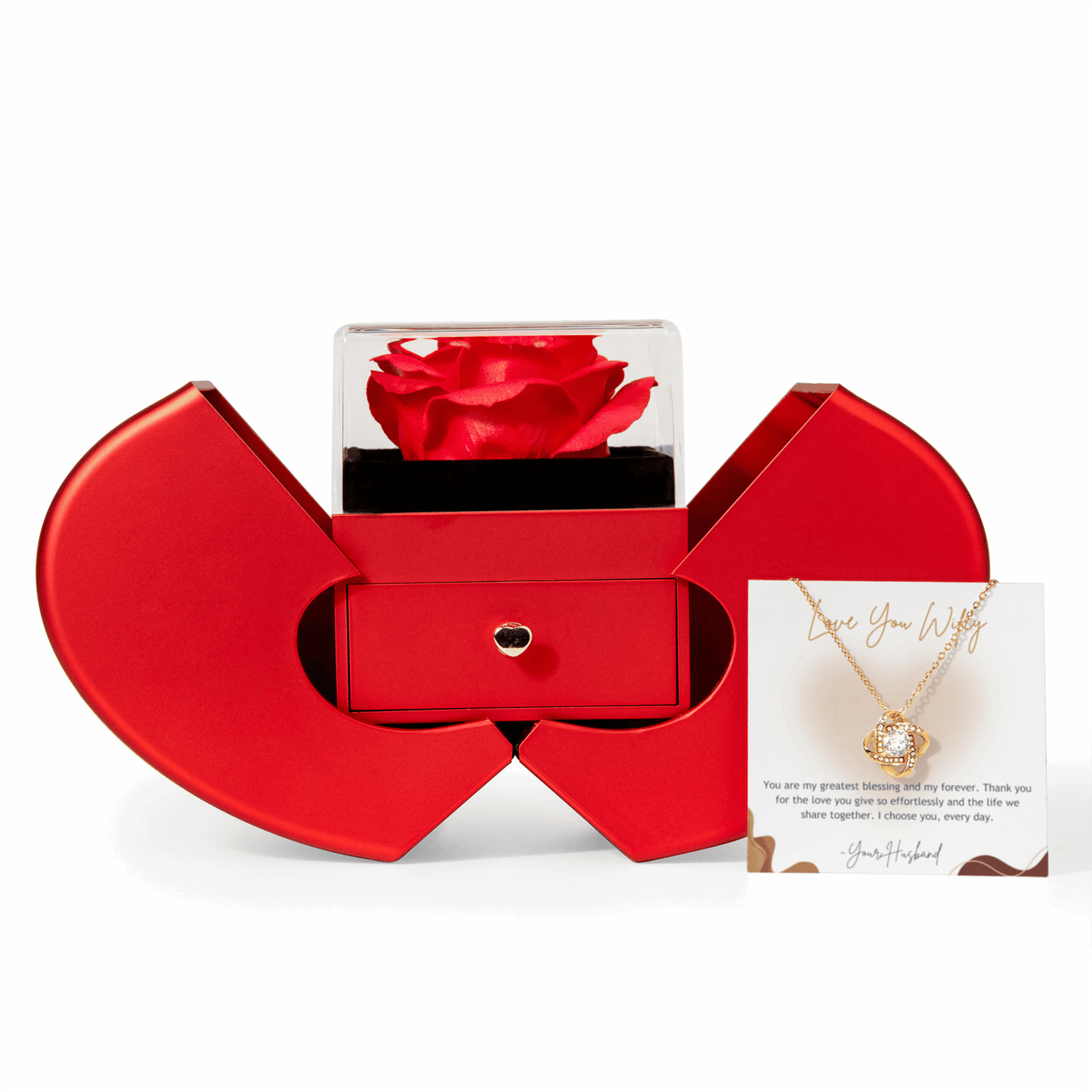 Red heart-shaped box with a red rose and a necklace on a white background