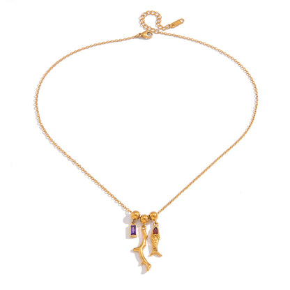 Gold necklace with charms on a white background