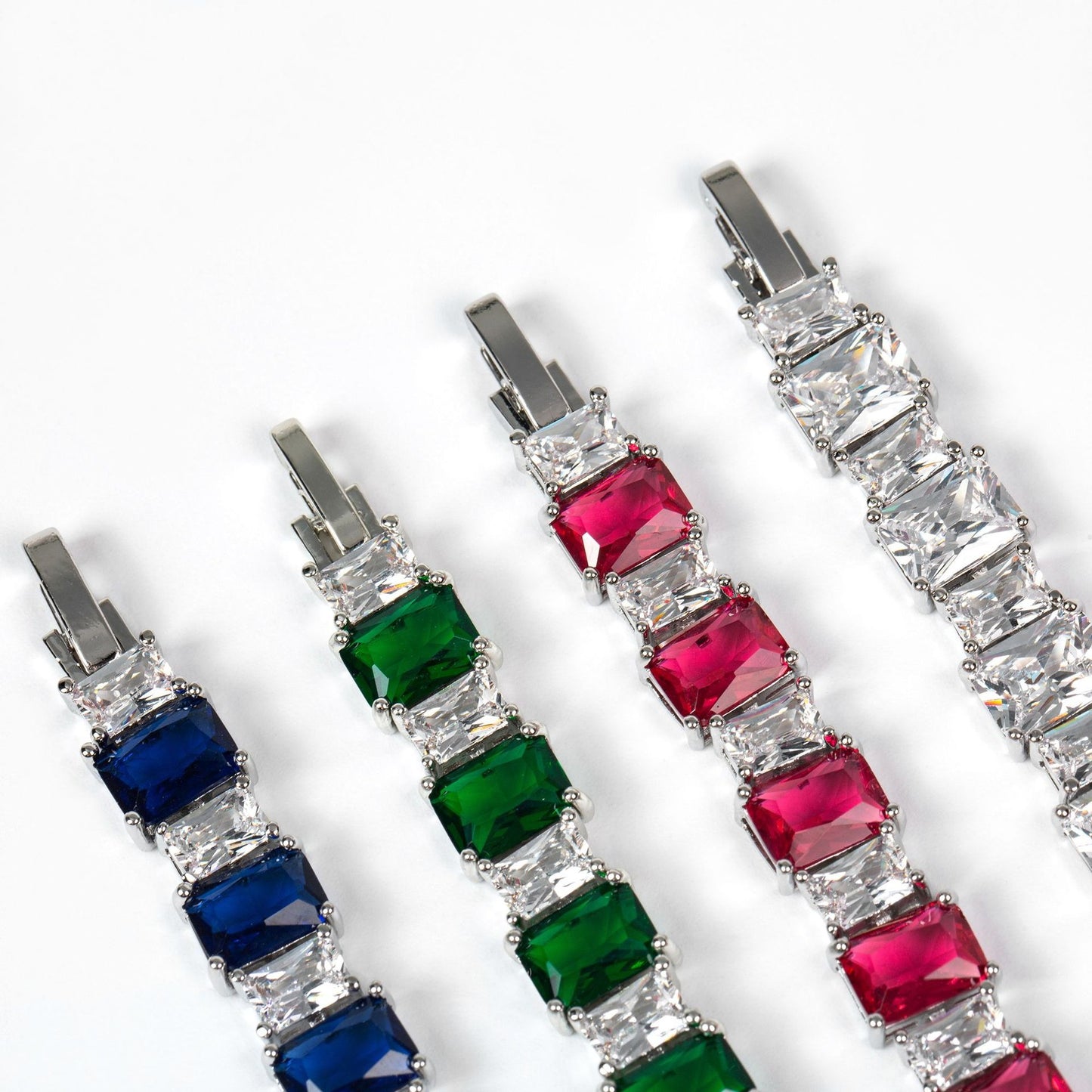 Jewelry bracelet with red, green, and blue gemstones on a white background