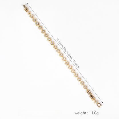 Gold bracelet with measurement details on a white background