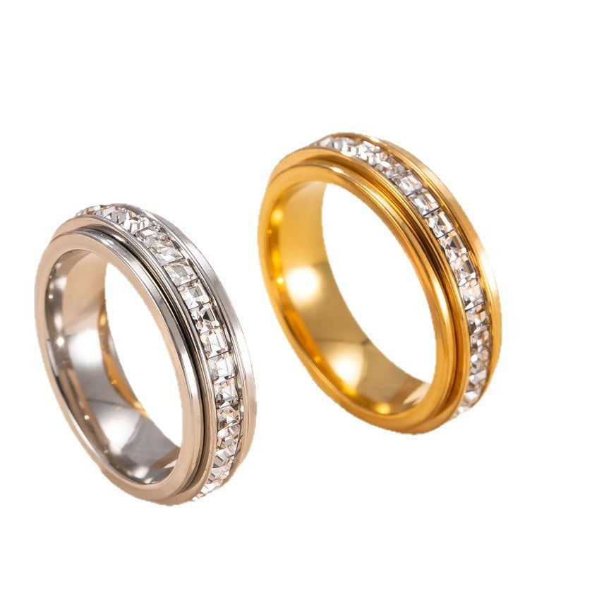 Two gold rings with diamond-studded bands on a white background