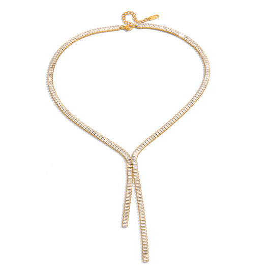 Gold necklace with a bow design on a white background