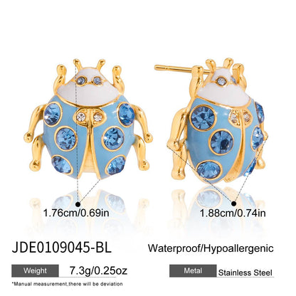 Blue and gold ladybug earrings with measurements and material details on a white background
