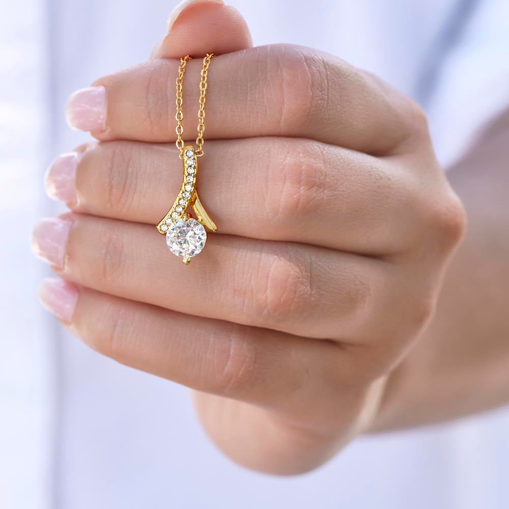 a beautiful is holding the shining necklace 