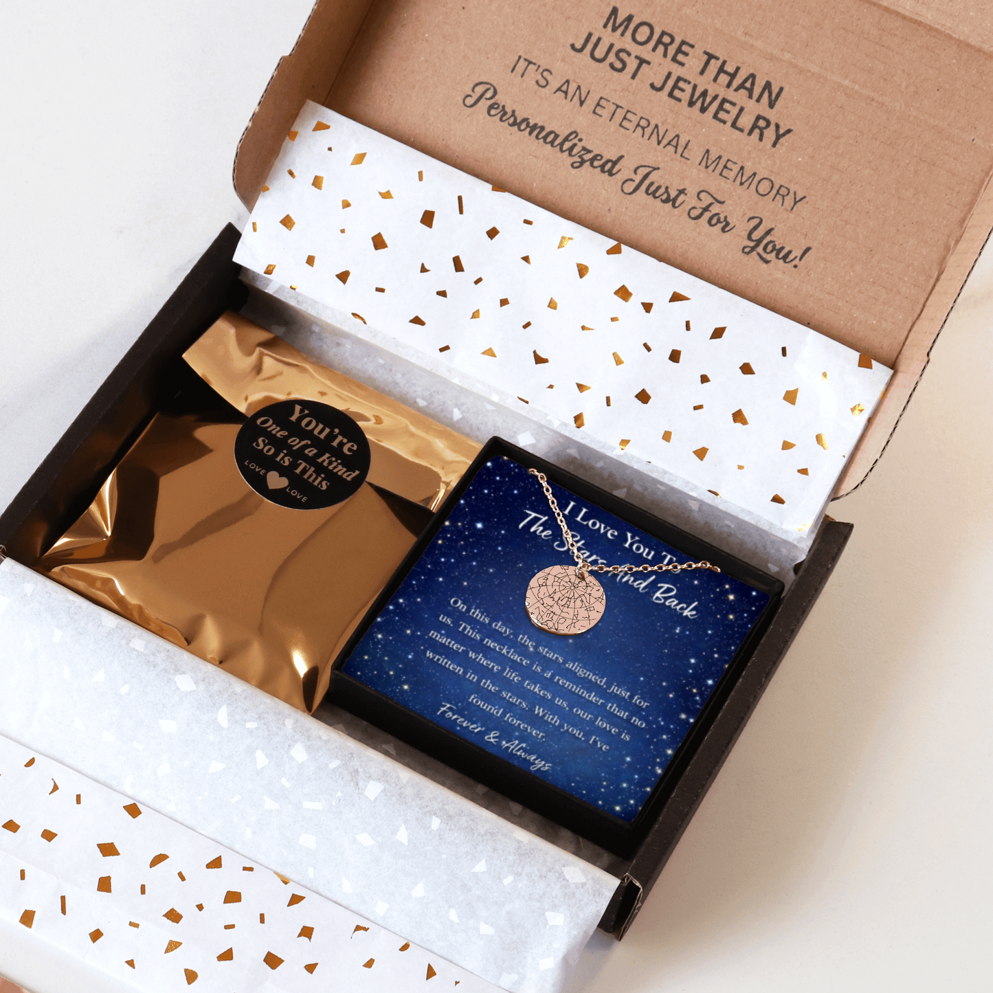 Jewelry box with a necklace and card inside, featuring gold and blue colors.