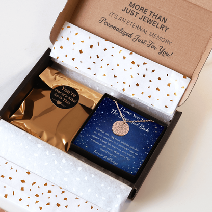Jewelry box with a necklace and card inside, featuring gold and blue colors.