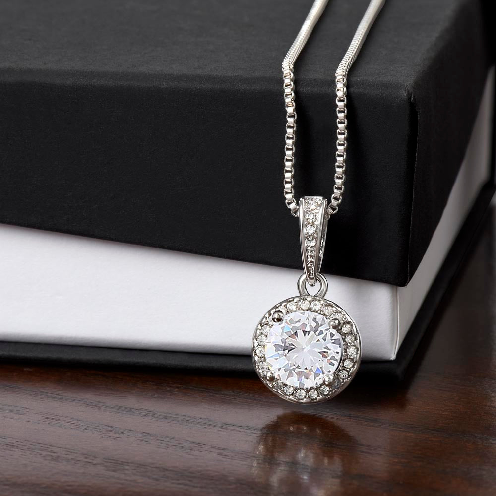 eternal hope necklace in front of a standard box  