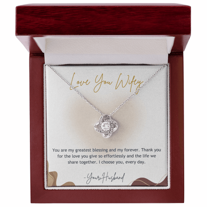 Silver necklace with a heart-shaped pendant in a wooden box with a message card.
