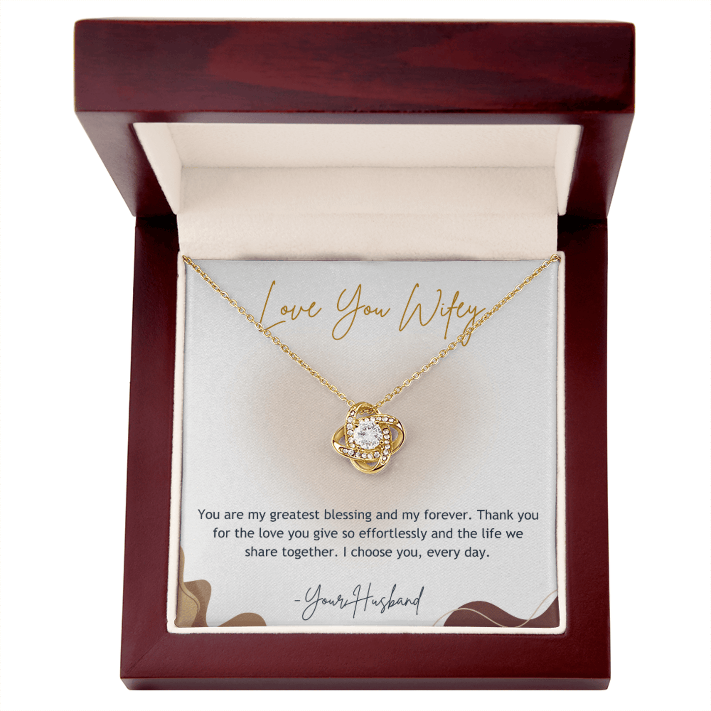 Gold necklace with heart design in a wooden box with a sentimental message card.
