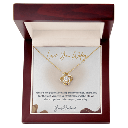 Gold necklace with heart design in a wooden box with a sentimental message card.