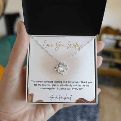 Necklace in a gift box with a sentimental message, held by a hand.