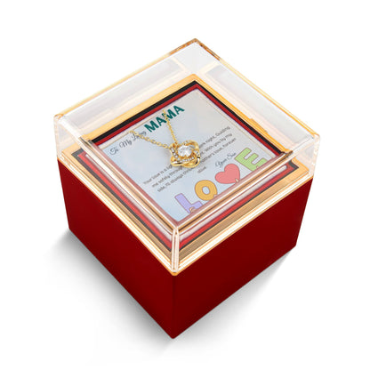 Love knot gold color necklace in a Rotating rose gift box with a message card in a white background