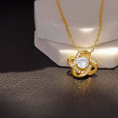 a glowing  love knot necklace in a beautiful modern studio background