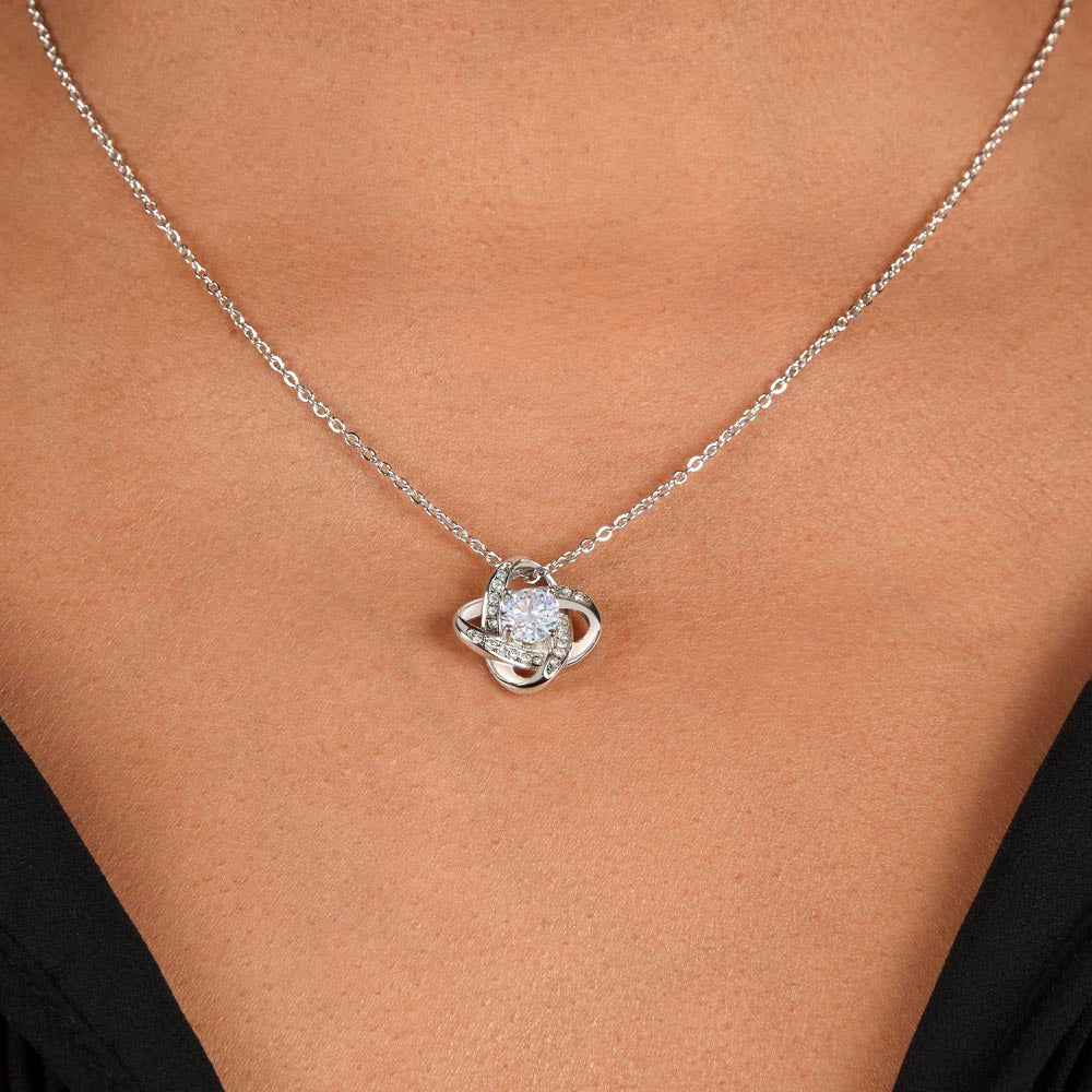a women has worn love knot necklace 