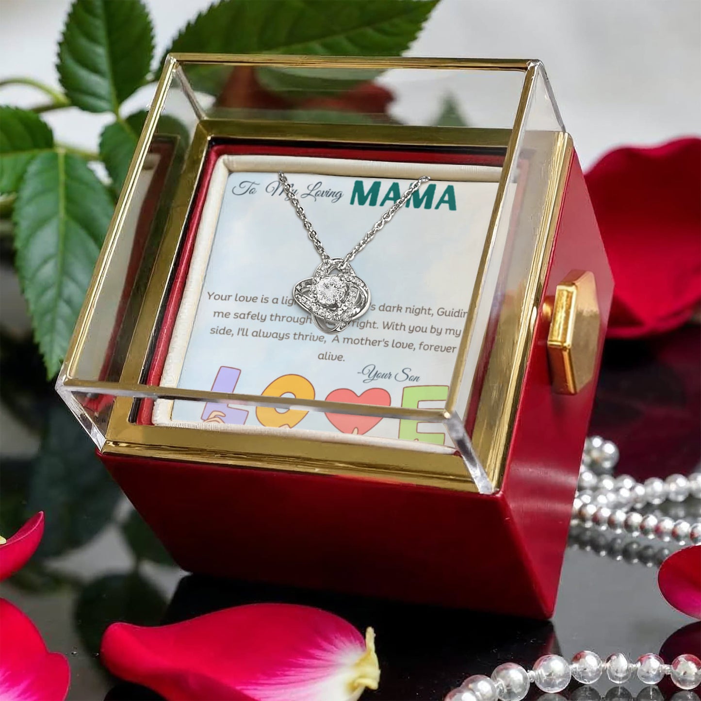 Love knot white gold color necklace in a Rotating rose gift box with a message card in  a studio background