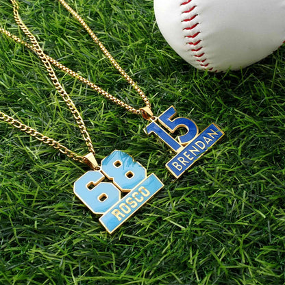 Two necklaces with numbers and names on grass next to a baseball
