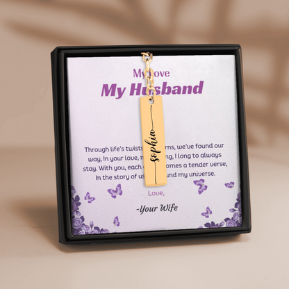 Gold necklace with a name tag in a decorative box with text