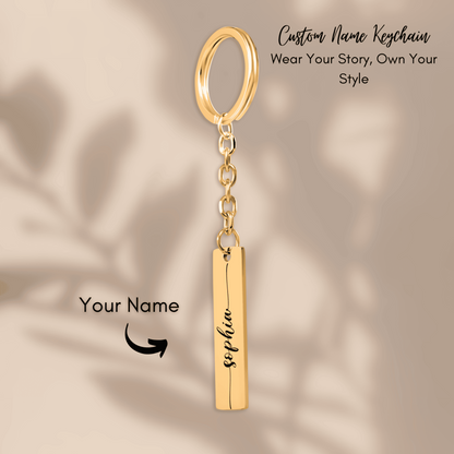 Gold keychain with a bar pendant on a beige background