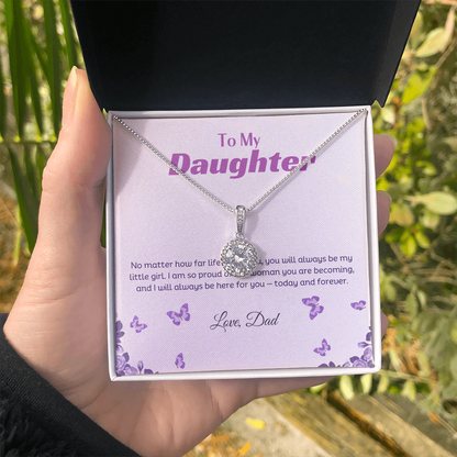 a lady hand holding the box with the necklace in a natural background