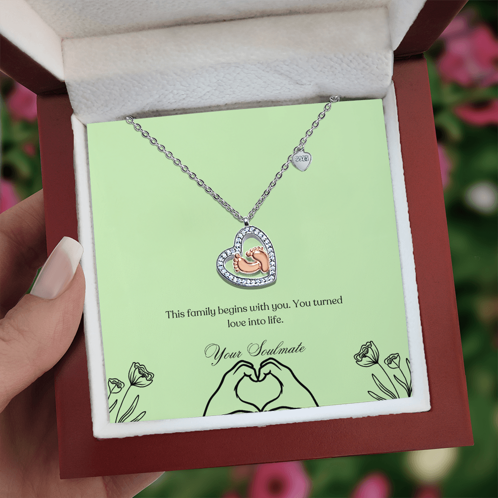 Baby feet necklace in a wooden box with LED in a girls hand