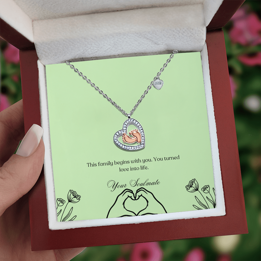 Baby feet necklace in a wooden box with LED in a girls hand