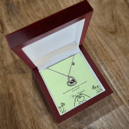 Baby feet necklace in a wooden box with LED in table