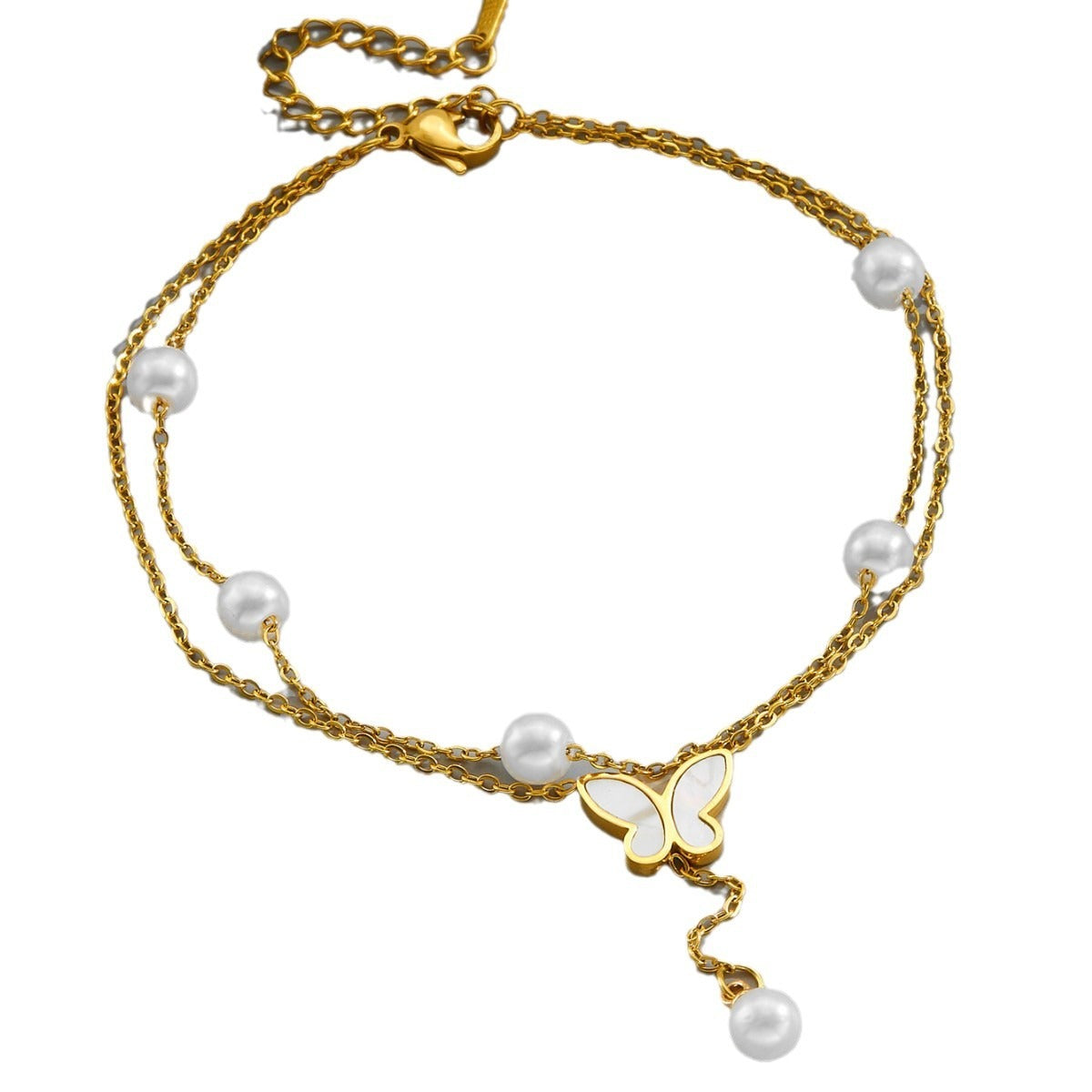 Gold anklet with pearls and a butterfly charm on a white background