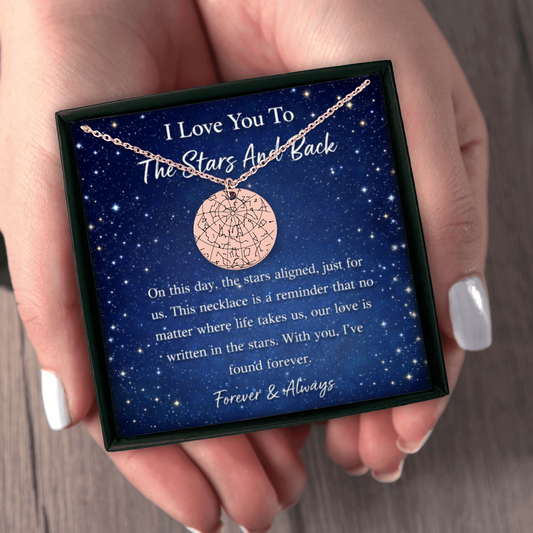 Necklace with star design in a box with sentimental message, held by a hand.