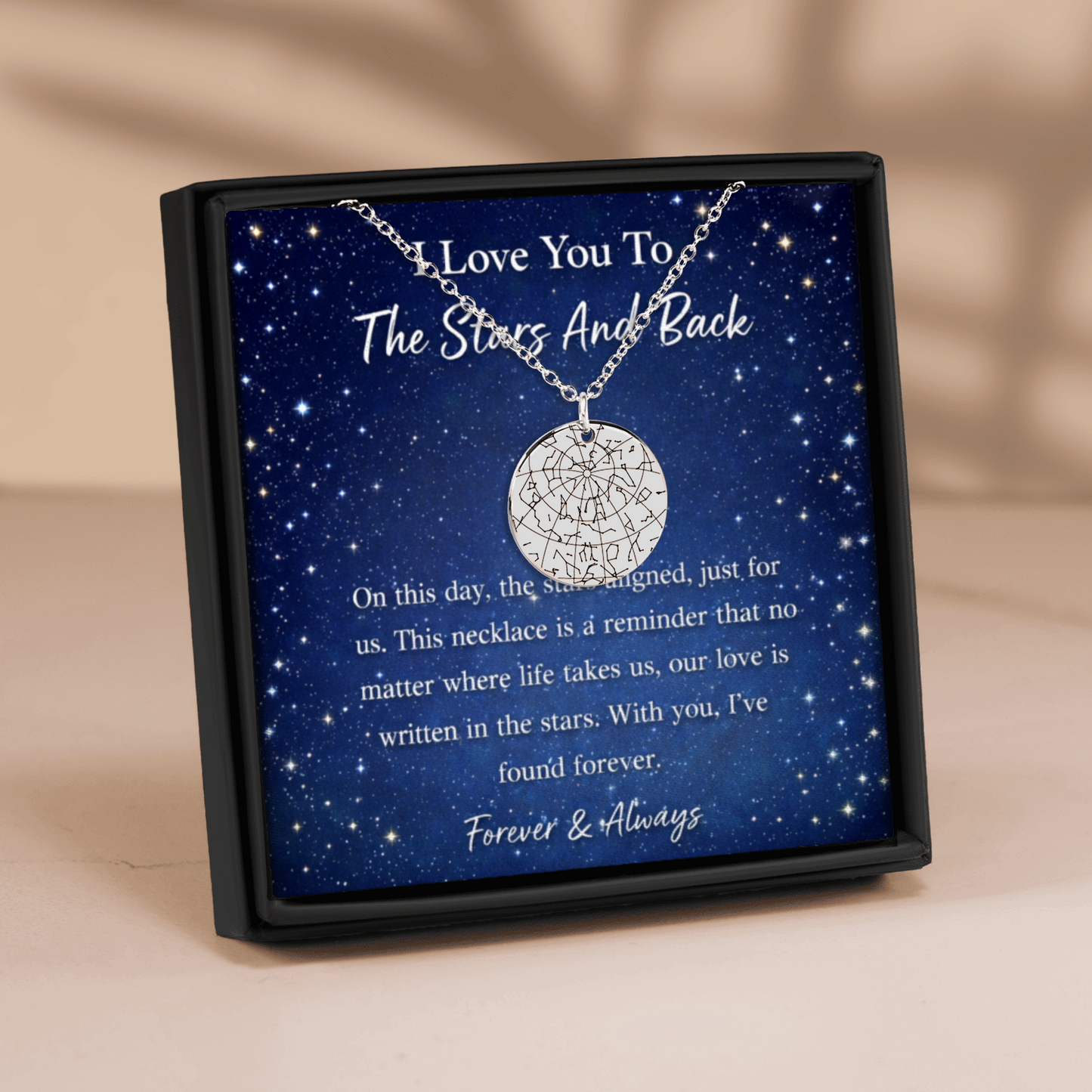 Necklace in a box with a starry night design and sentimental message.