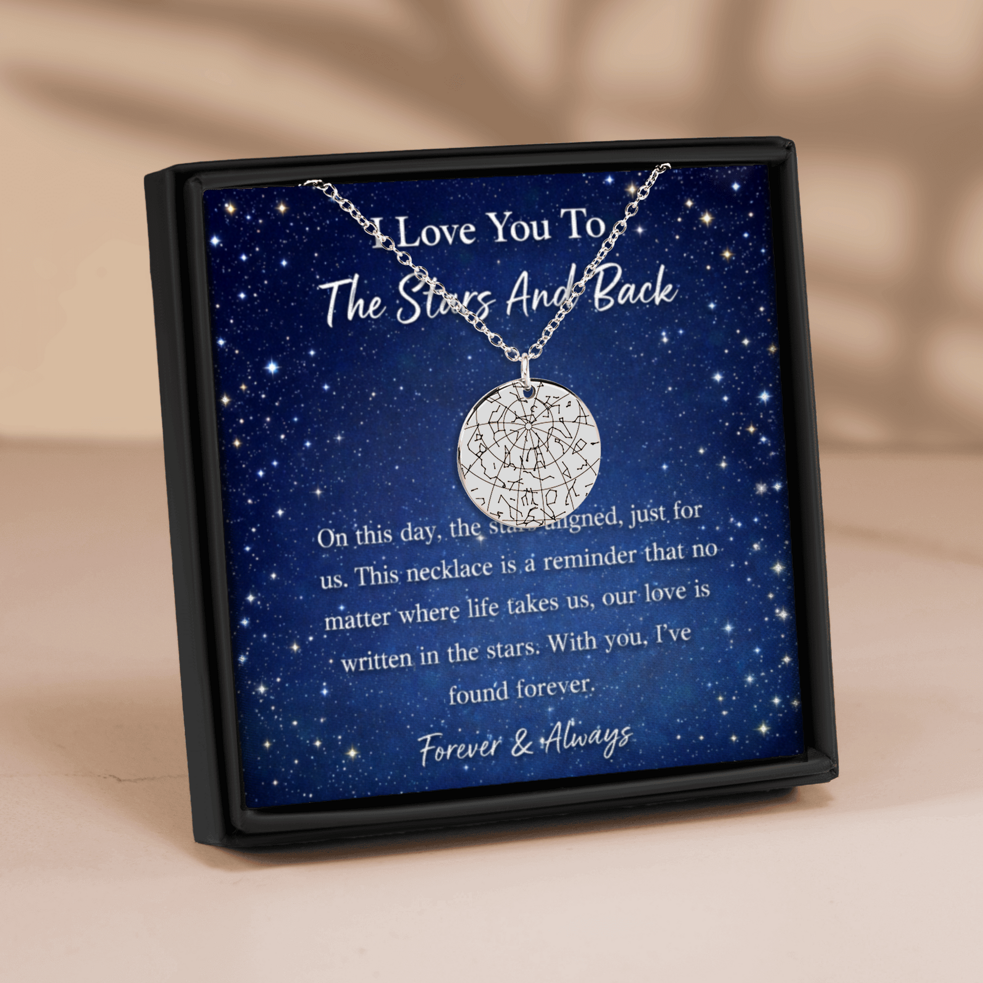 Necklace in a box with a starry night design and sentimental message.