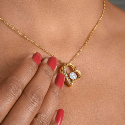 A women is touching her forever love necklace  with her hand painted  with red nail polish 