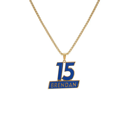 Gold necklace with a blue pendant displaying '15 Brendan' on a white background